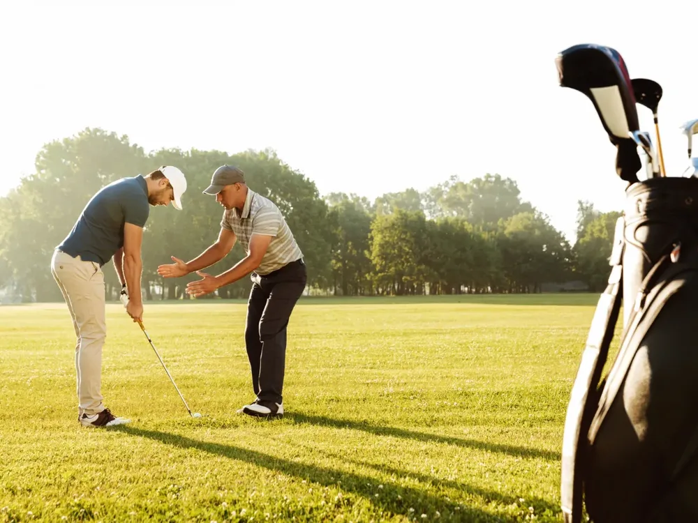 Golfer working through a swing and mobility screen with a physical therapist
