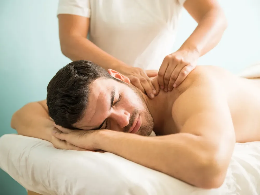 Therapist providing recovery-focused soft tissue massage